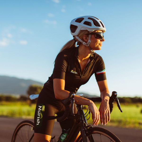 Woman riding bike wearing MyNurish shorts